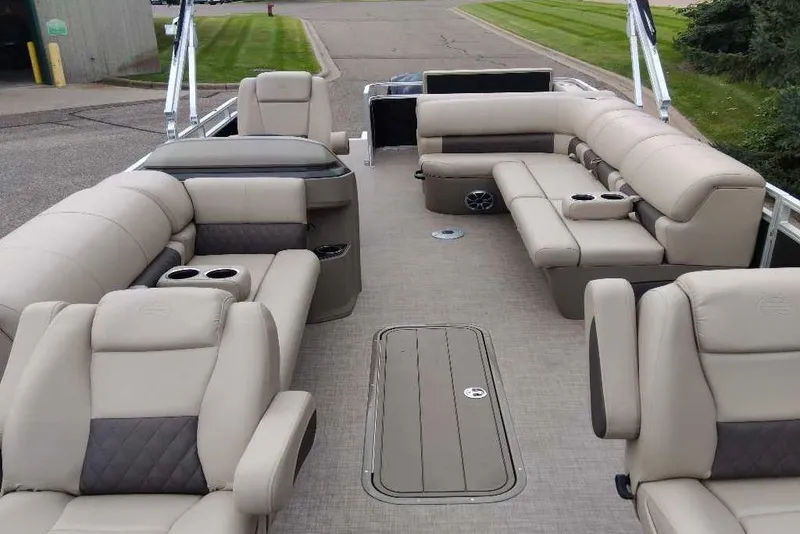 Slide: The Image of 2025 Sun Tracker Sportfish 24 XP3 pontoon boat interior with luxurious seating and cup holders. - 2