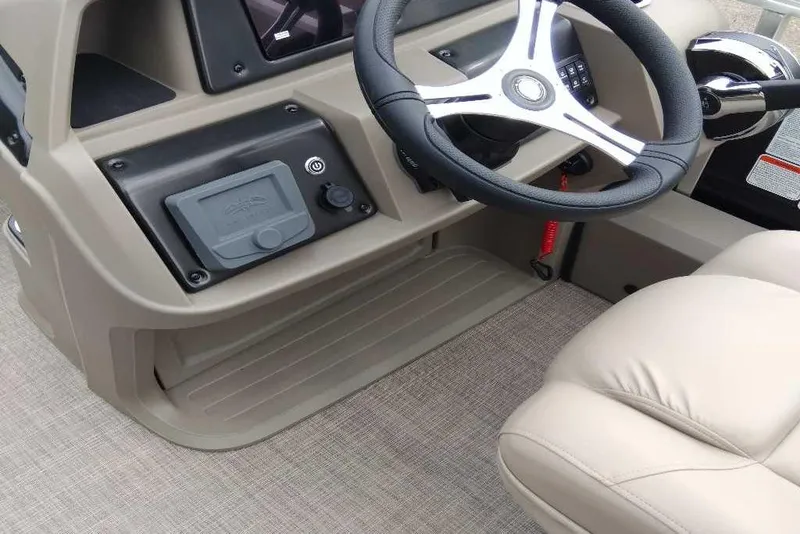 Slide: The Image of 2025 Sun Tracker Sportfish 24 XP3 boat interior with steering wheel and control panel. - 3