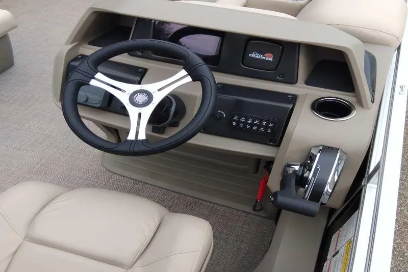 Slide: The Image of 2025 Sun Tracker Sportfish 24 XP3 boat dashboard with steering wheel and controls. - 4