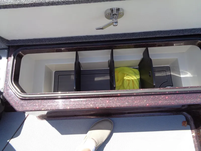 Slide: The Image of Storage compartment of 2022 Ranger 621 FS PRO boat with dividers and yellow cloth. - 11