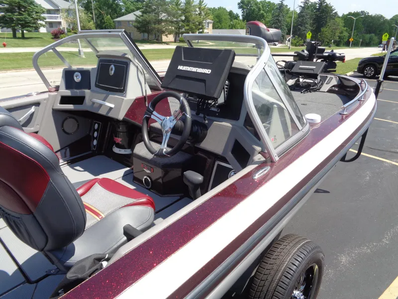 Slide: The Image of 2022 Ranger 621 FS PRO boat with modern dashboard and seating, parked outdoors. - 19