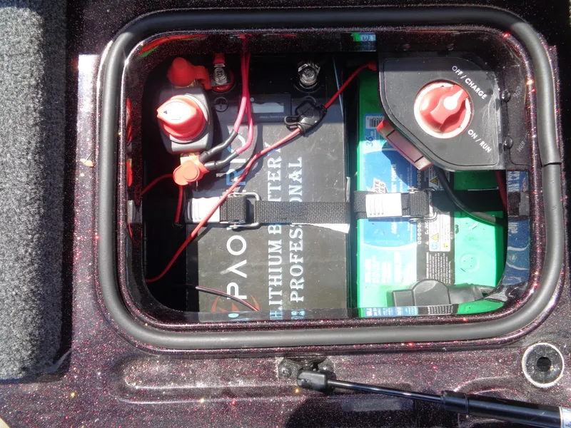 Slide: The Image of 2022 Ranger 621 FS PRO battery compartment with lithium battery and power switch. - 2