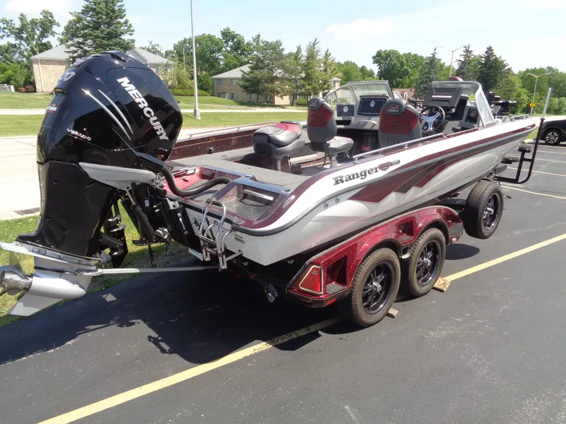 Slide: The Image of 2022 Ranger 621 FS PRO boat with Mercury engine on a trailer in a parking lot. - 26