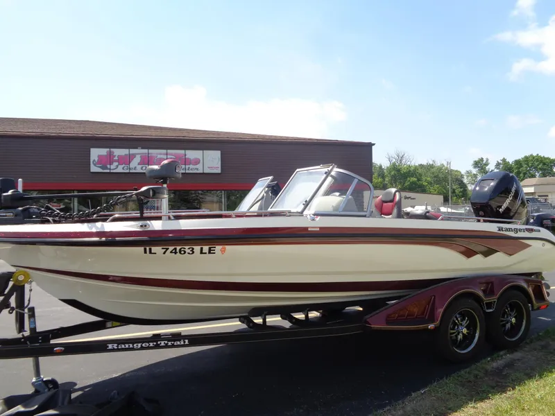 Slide: The Image of 2022 Ranger 621 FS PRO boat on trailer, parked outside a building. - 29