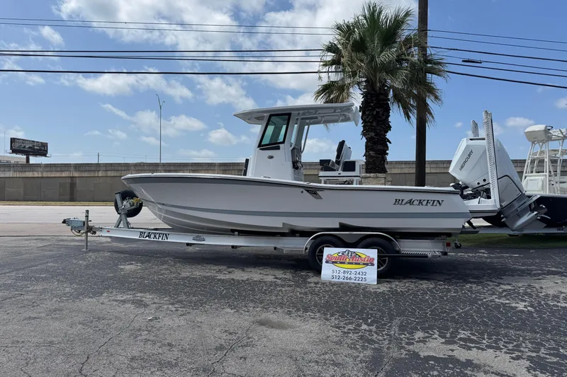 The Image of 2026 Blackfin 262 HB boat on trailer, parked outdoors under a clear sky. - 0