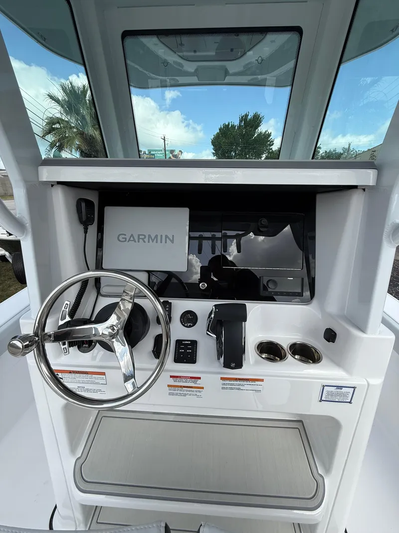 Slide: The Image of Helm of 2026 Blackfin 262 HB boat with Garmin navigation system and steering wheel. - 11