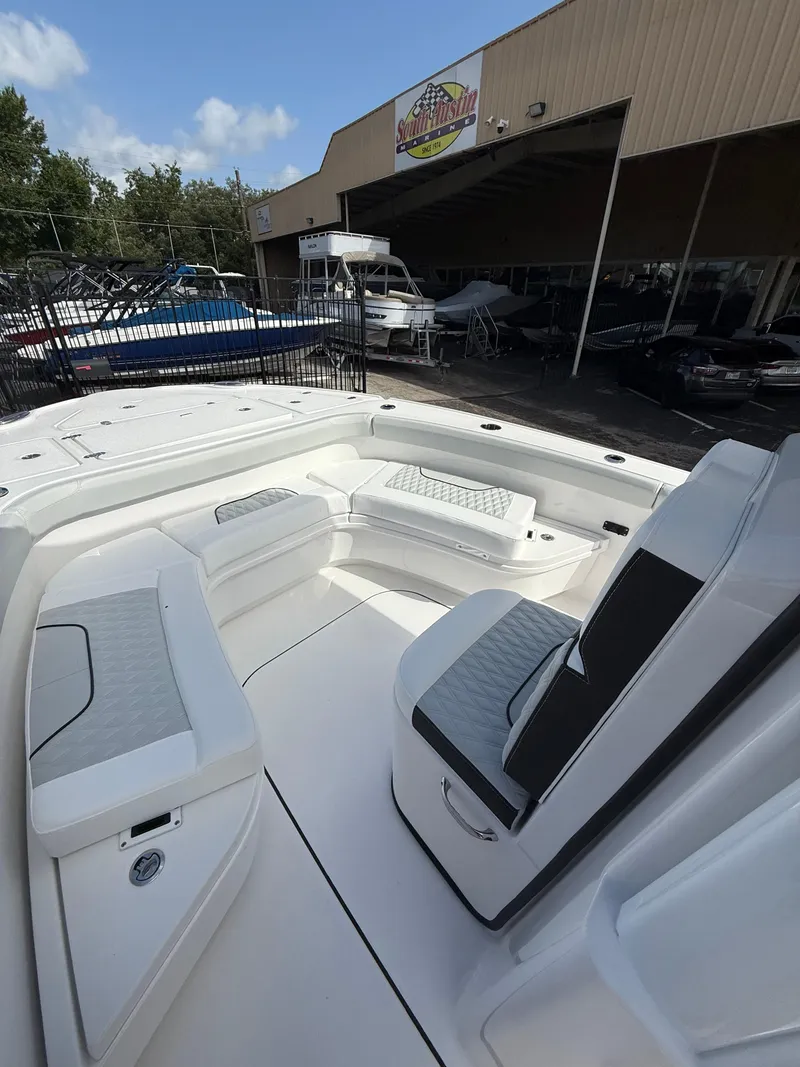 Slide: The Image of 2026 Blackfin 262 HB boat interior with seating, displayed at a dealership. - 15