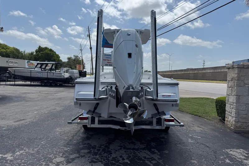 Slide: The Image of 2026 Blackfin 262 HB boat on trailer, rear view, parked outdoors. - 2