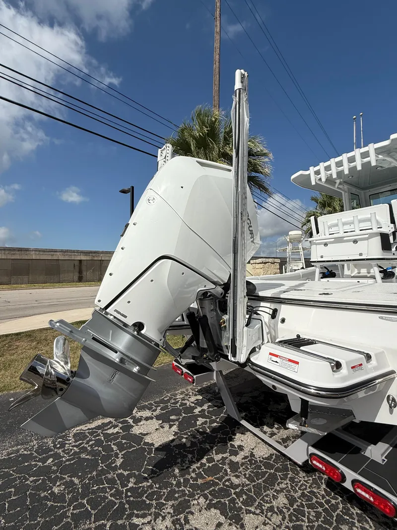 Slide: The Image of 2026 Blackfin 262 HB boat with powerful outboard motor, parked on a sunny day. - 3