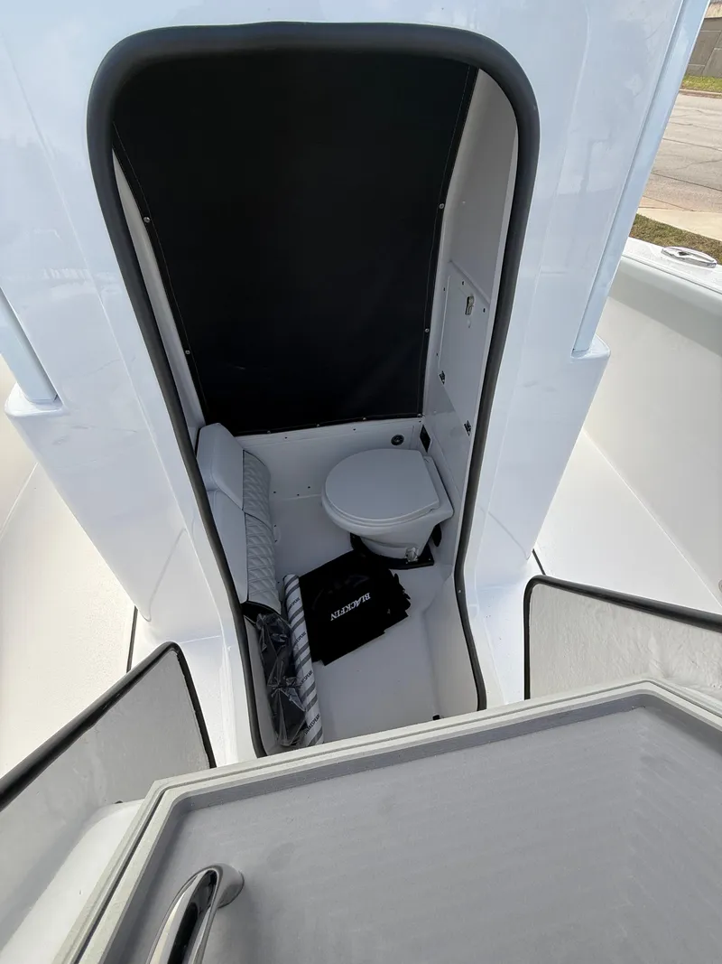 Slide: The Image of 2026 Blackfin 262 HB boat interior with compact cabin and seating area. - 8