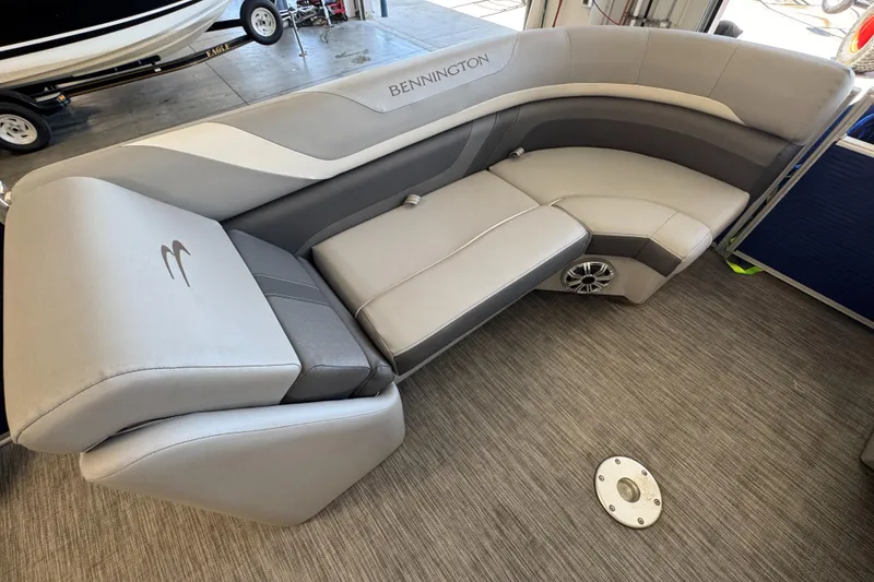 Slide: The Image of 2020 Bennington SX 22 SSRX boat interior with gray seating and speaker. - 17