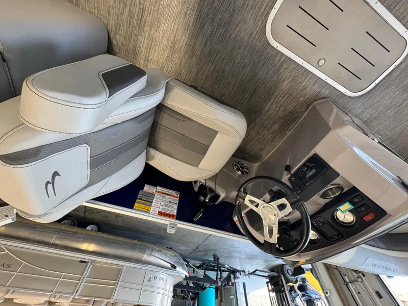 Slide: The Image of 2020 Bennington SX 22 SSRX boat interior with steering wheel and seating. - 5