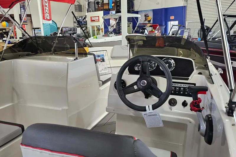 Slide: The Image of 2023 Bayliner Element M19 boat interior with steering wheel and dashboard controls. - 3