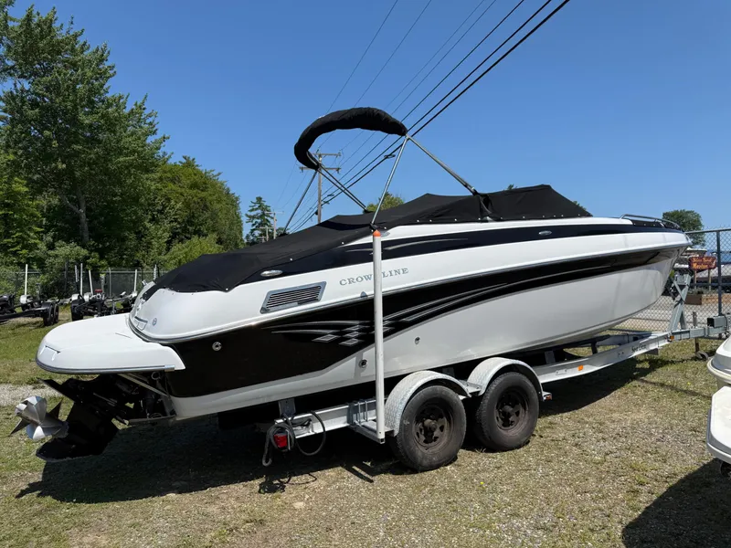 Slide: The Image of 2007 Crownline 270 BR boat on trailer, black and white design, parked outdoors. - 2