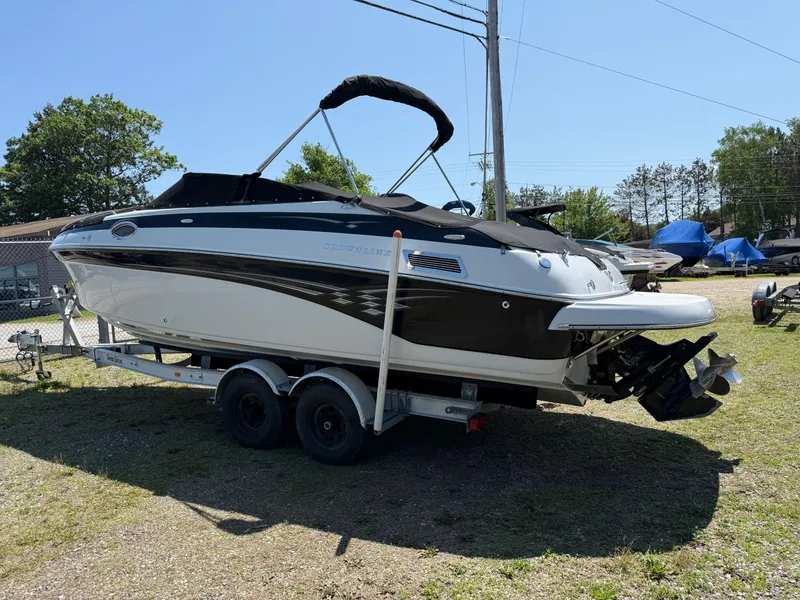 Slide: The Image of 2007 Crownline 270 BR boat on trailer, parked outdoors under clear sky. - 3