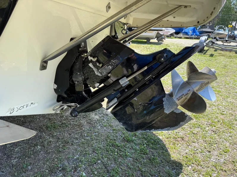 Slide: The Image of 2007 Crownline 270 BR boat propeller and outdrive on grass. - 5