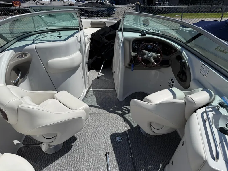 Slide: The Image of 2007 Crownline 270 BR boat interior with white seating and steering console. - 7