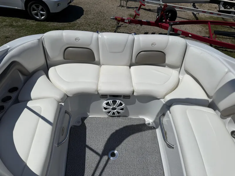 Slide: The Image of 2007 Crownline 270 BR boat interior with white seating and speaker system. - 8