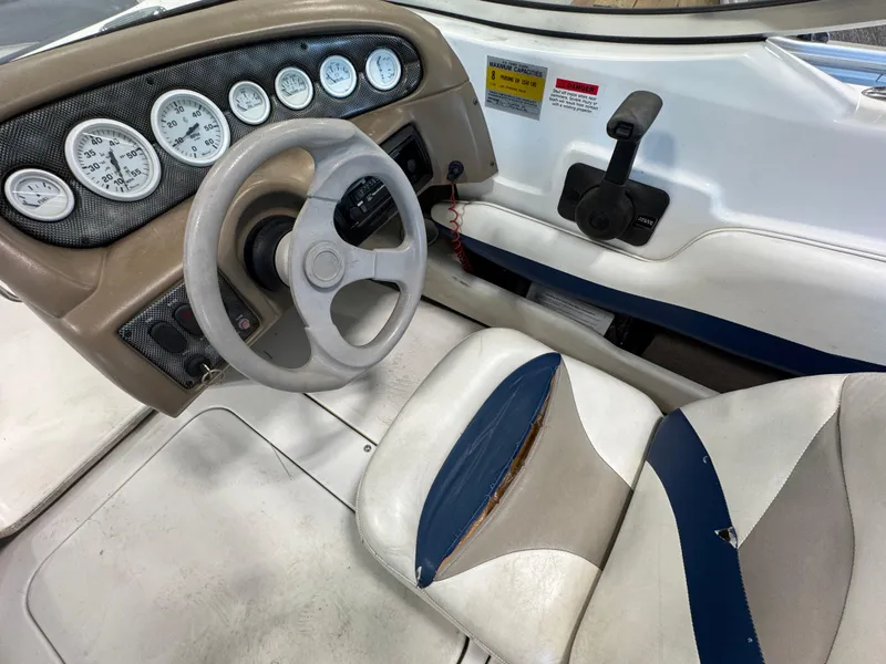 Slide: The Image of 2001 Glastron SX175 boat cockpit with steering wheel and dashboard gauges. - 11