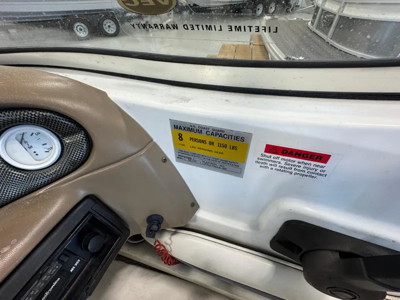 Slide: The Image of 2001 Glastron SX175 boat dashboard with capacity and safety warning labels. - 12