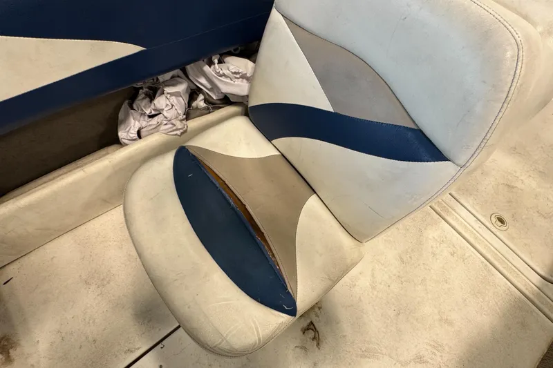 Slide: The Image of Worn seat of a 2001 Glastron SX175 boat with blue and beige upholstery. - 16