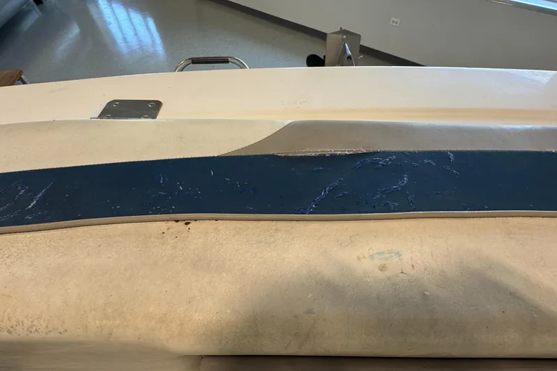 Slide: The Image of 2001 Glastron SX175 boat interior with worn upholstery and blue trim detail. - 17