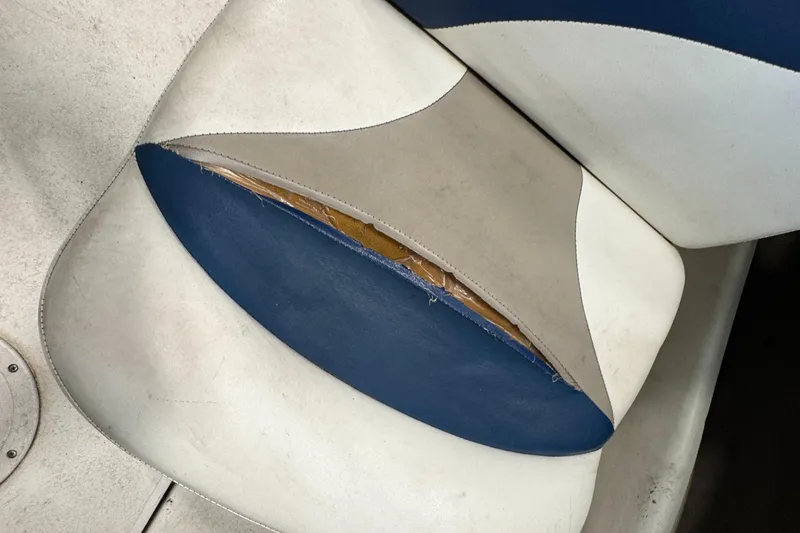 Slide: The Image of Torn seat upholstery on a 2001 Glastron SX175 boat, showing wear and damage. - 18