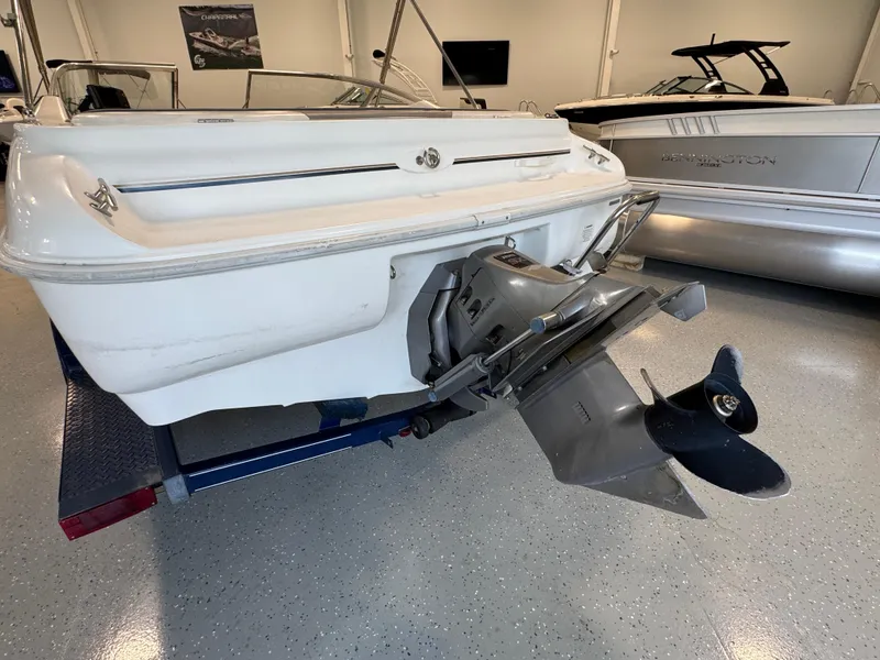 Slide: The Image of 2001 Glastron SX175 boat stern with outboard motor in showroom. - 3
