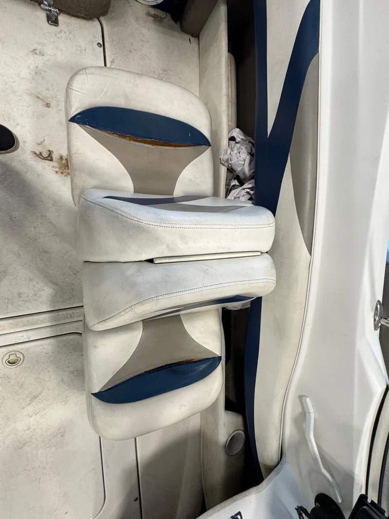 Slide: The Image of 2001 Glastron SX175 boat interior with white and blue seating. - 9
