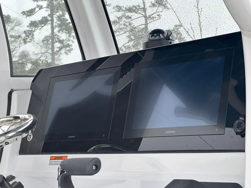 Slide: The Image of 2025 Sportsman Heritage 231 Center Console dashboard with dual Garmin displays. - 12
