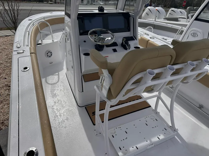 Slide: The Image of 2025 Sportsman Heritage 231 Center Console boat interior with helm and seating. - 17
