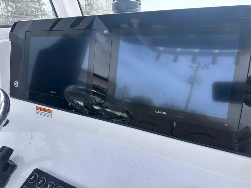 Slide: The Image of 2025 Sportsman Heritage 231 Center Console with dual Garmin displays on the dashboard. - 19