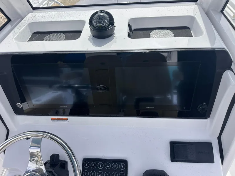 Slide: The Image of 2025 Sportsman Heritage 231 Center Console dashboard with Garmin displays and Ritchie compass. - 20