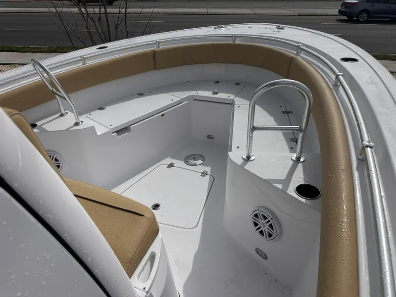 Slide: The Image of 2025 Sportsman Heritage 231 Center Console boat interior with cushioned seating and stainless steel rails. - 21