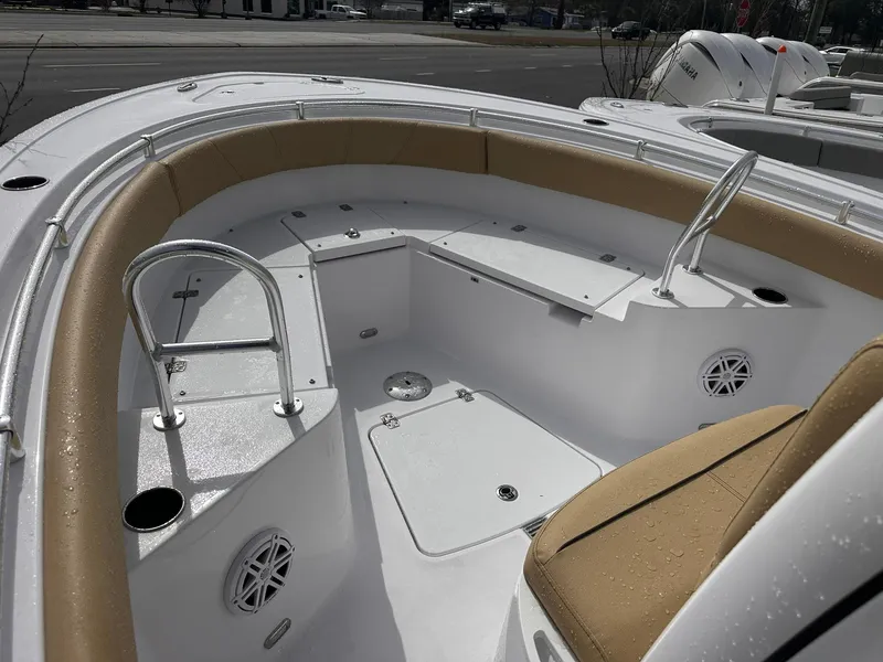 Slide: The Image of 2025 Sportsman Heritage 231 Center Console boat interior with tan seating and stainless steel rails. - 22