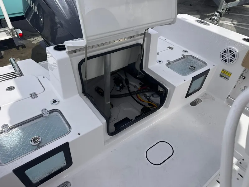 Slide: The Image of 2025 Sportsman Heritage 231 Center Console boat interior with open storage compartment. - 24