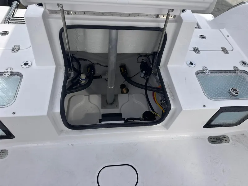 Slide: The Image of 2025 Sportsman Heritage 231 Center Console boat interior, showcasing open storage compartment and wiring. - 25