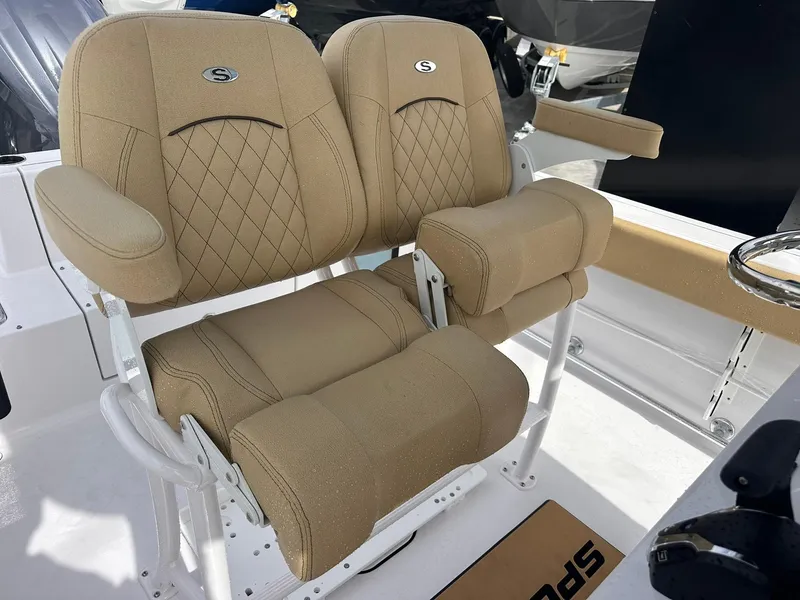 Slide: The Image of 2025 Sportsman Heritage 231 Center Console boat seats with tan upholstery and diamond stitching. - 28