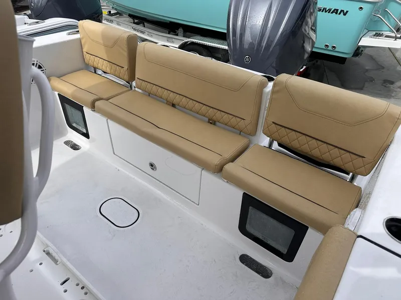 Slide: The Image of 2025 Sportsman Heritage 231 Center Console boat with tan cushioned seating. - 29