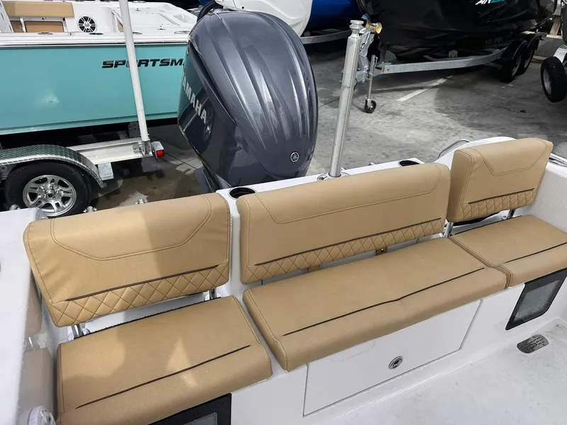 Slide: The Image of 2025 Sportsman Heritage 231 Center Console boat with tan seating and Yamaha engine. - 31