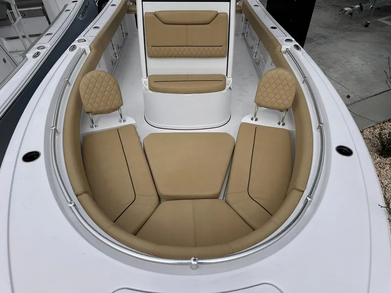 Slide: The Image of 2025 Sportsman Heritage 231 Center Console boat with tan cushioned seating. - 37