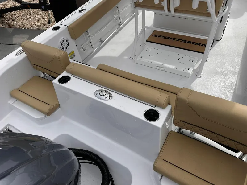 Slide: The Image of 2025 Sportsman Heritage 231 Center Console boat interior with tan seating and cup holders. - 38