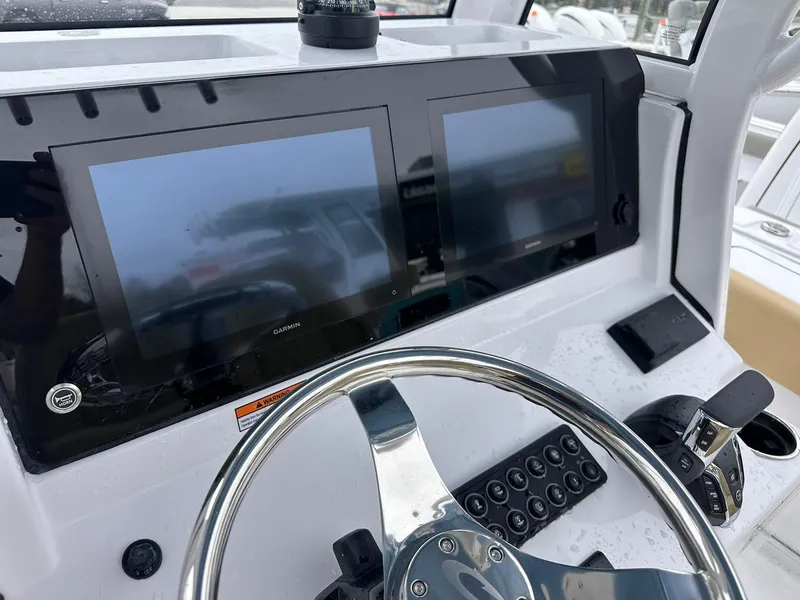 Slide: The Image of 2025 Sportsman Heritage 231 Center Console dashboard with dual Garmin displays and steering wheel. - 44