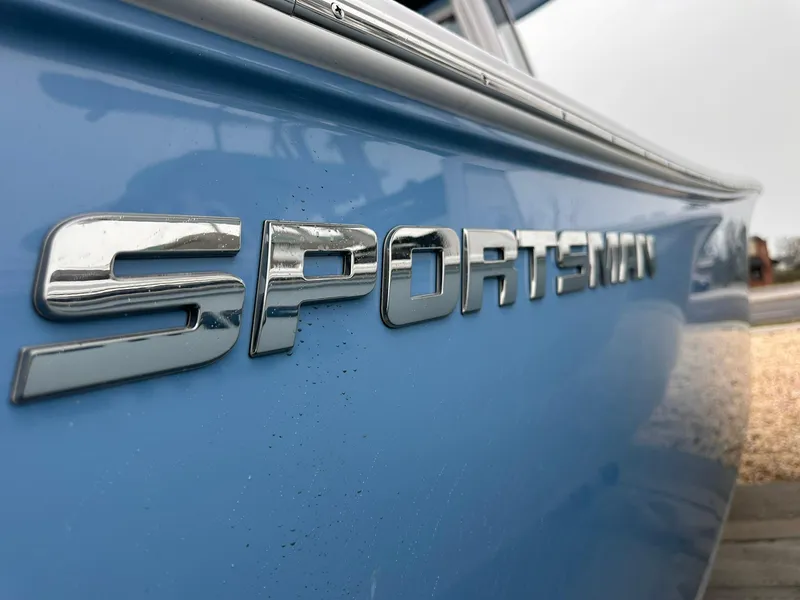 Slide: The Image of Close-up of 2025 Sportsman Heritage 231 Center Console boat logo on blue hull. - 5