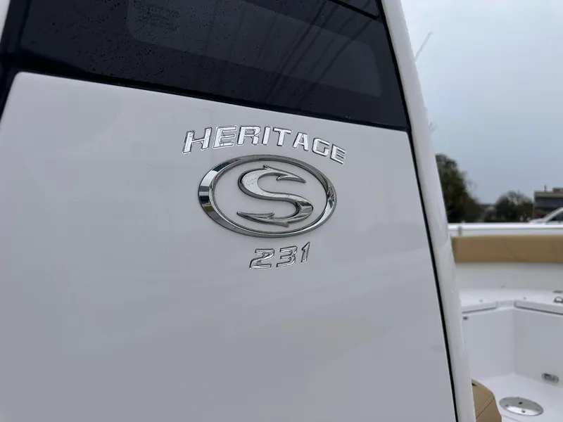 Slide: The Image of 2025 Sportsman Heritage 231 Center Console boat emblem on white surface. - 7