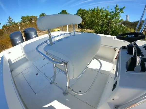 Slide: The Image of 1999 Contender 28 Sport boat interior with white seating and dual 300 engines. - 10