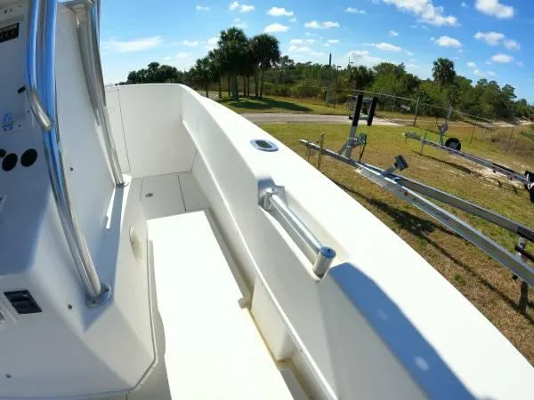 Slide: The Image of 1999 Contender 28 Sport boat interior with railing, sunny outdoor setting. - 12