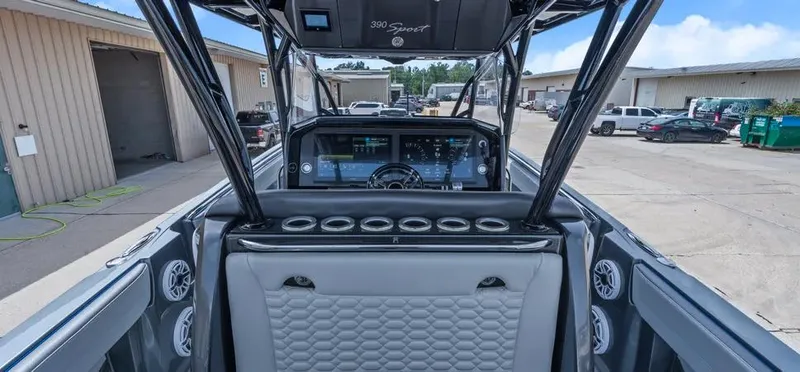 Slide: The Image of 2023 Nor-Tech 390 Sport Center Console boat interior with advanced dashboard and seating. - 12