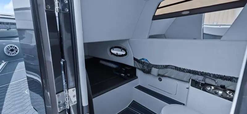 Slide: The Image of 2023 Nor-Tech 390 Sport Center Console cabin interior with seating and storage. - 14