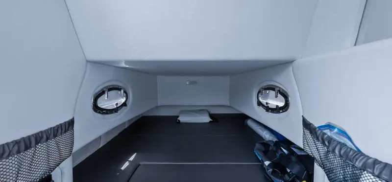 Slide: The Image of 2023 Nor-Tech 390 Sport Center Console cabin interior with portholes and storage compartments. - 15